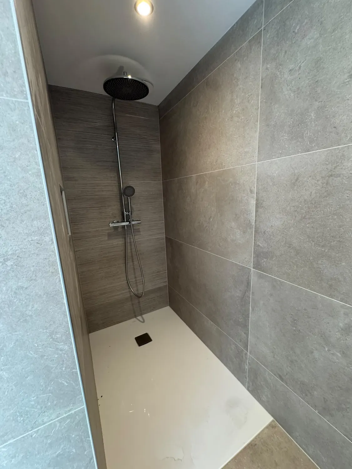 Douche à l'italienne carrelée avec colonne de douche, réalisée par ABL Chauffage